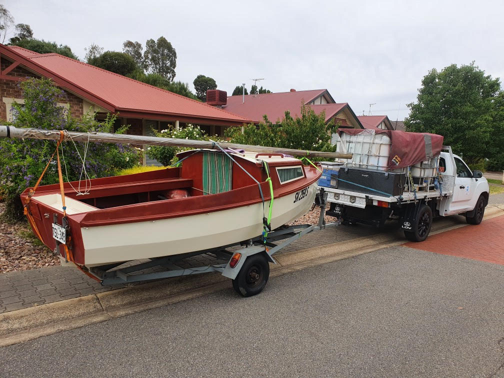 Small boat being towed on trailer